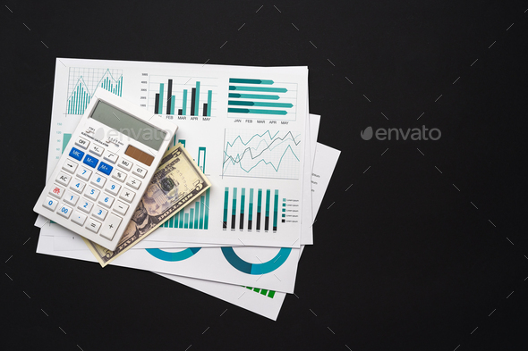 Business graphs paper and calculator on table - Stock Photo - Images