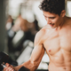 strong man exercising in the sport gym, workout exercise training in fitness  for body strong Stock Photo by ckstockphoto