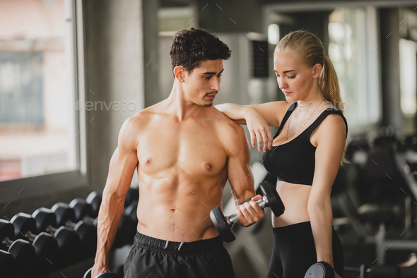 Premium Photo  Female personal trainer helping woman doing