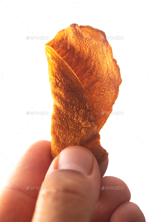 Vegetable chips in a man\'s hand isolated on white background