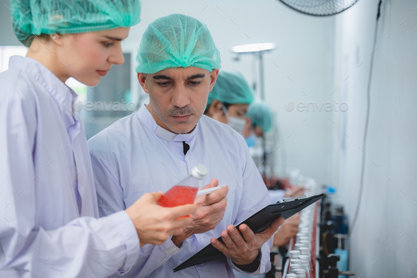 professional inspection control scientist in uniform working for fruit juice production