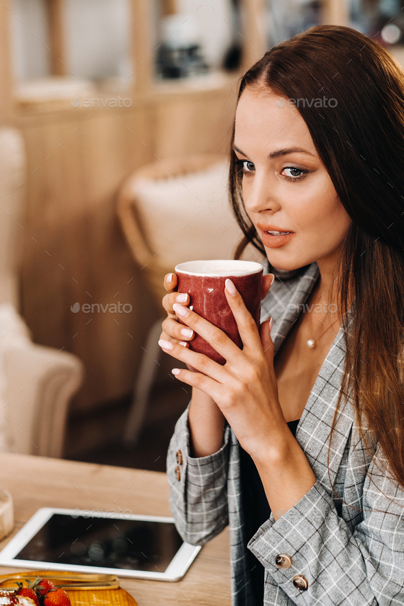 A Girl Drinks Coffee In A Coffee Shop Beautiful Hair Of A Girl Stock