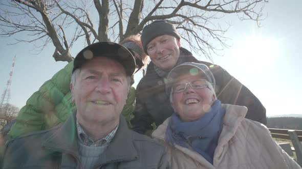Four Happy Seniors Smiling on Sunny Day in Winter