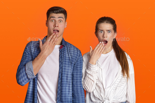 Funny surprised couple see something strange and scared