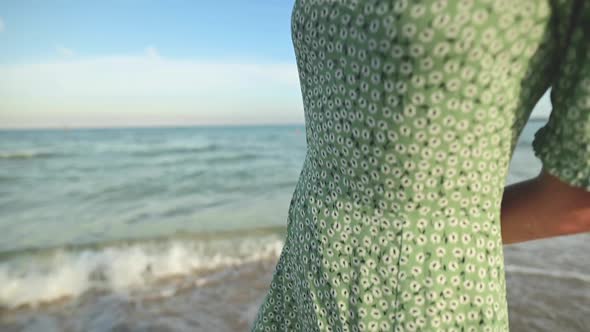 Romantic Portrait of Attractive Caucasian Young Woman in Green Dress and Straw Hat on the Seashore alt