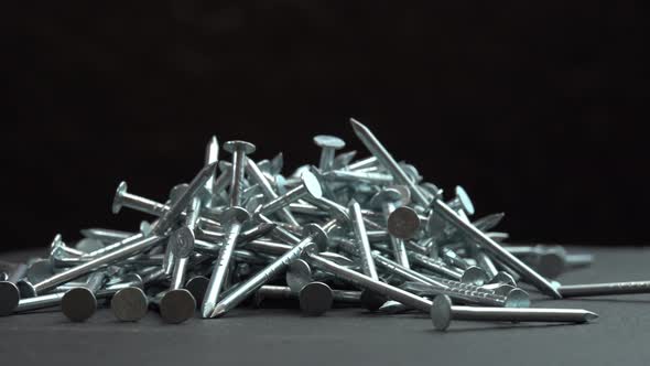 Hobnails are Spinning Close Up Background Metal Steel Nails for Construction Work Rotating on alt