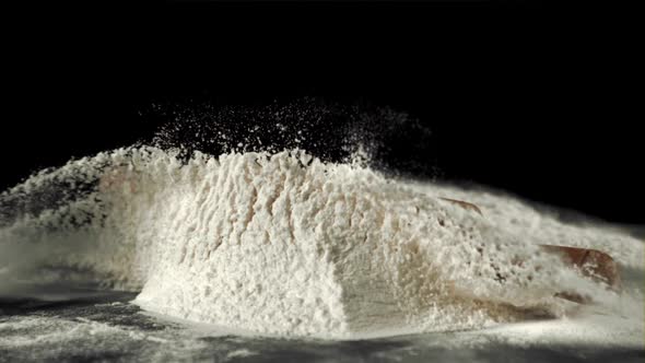 Super Slow Motion of the Rolling Pin Falls on the Table with Flour alt