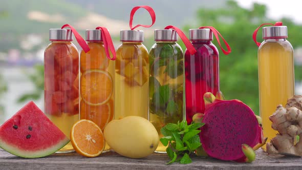 A Set of Colorful Glass Bottles with Different Flavors of Kombucha Drink Such As Watermelon Orange alt