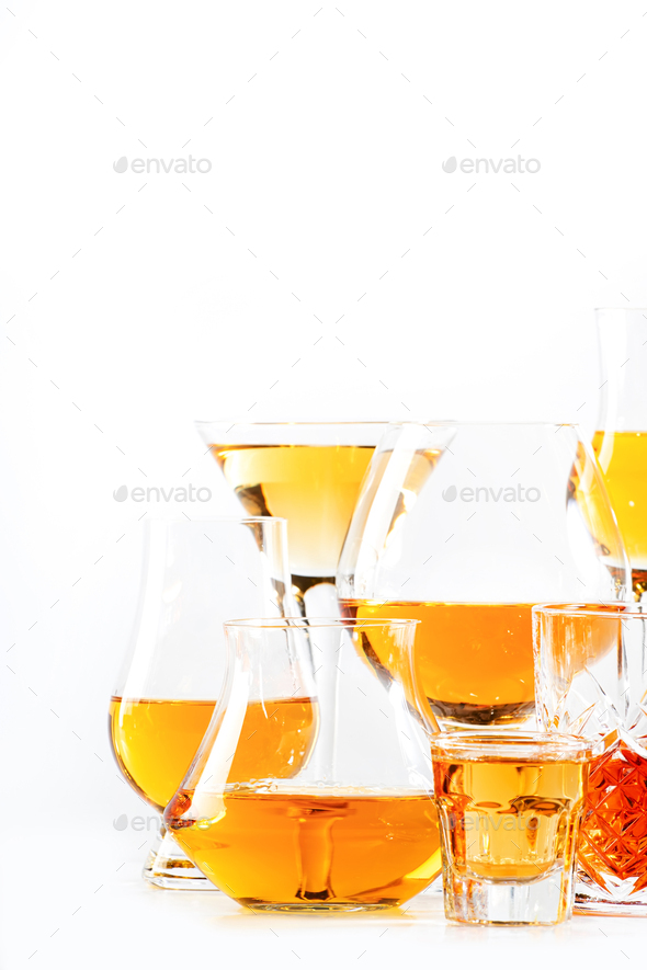 Strong alcohol drinks, hard liquors, spirits and distillates iset in glasses: cognac, scotch,