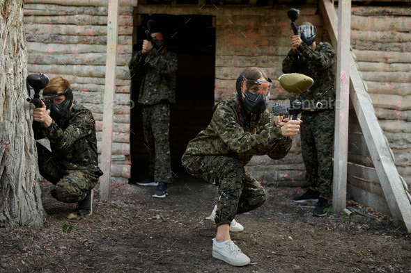 Paintball team fights on playground in the forest - Stock Photo - Images