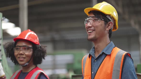Diverse group of engineer enjoy talking and laughing while working in the factory