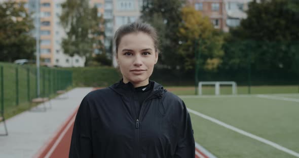 Crop View of Pretty Young Woman Smiling and Looking To Camera alt