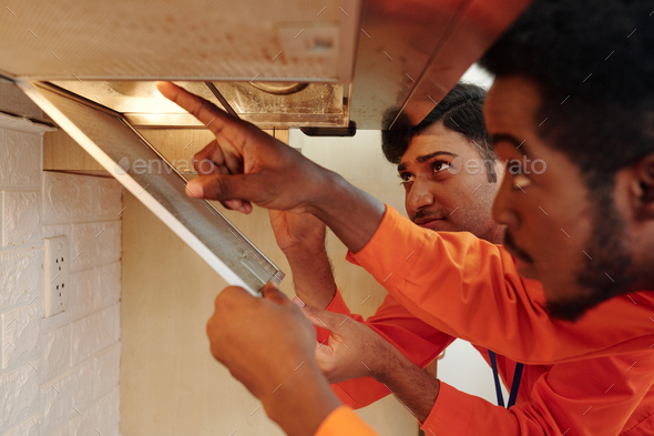 Workers Changing Lamps in Cooker Hood