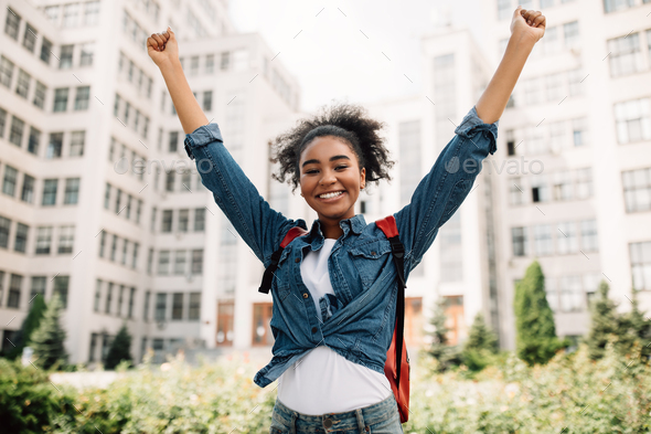 Black Student Girl Shaking Fists Celebrating Success In College Outdoor