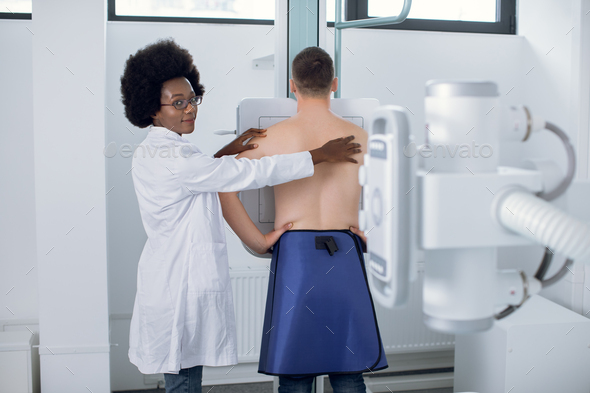 Young African woman doctor radiologist, or x-ray technician, conducting chest x-ray scanning of