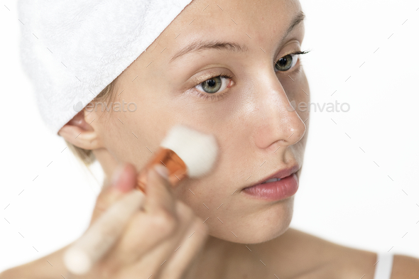 Portrait of white woman doing her daily makeup routine