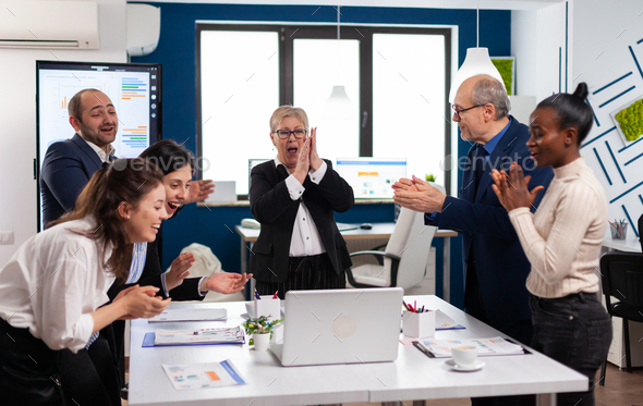 Diverse executive business team clapping in conference room