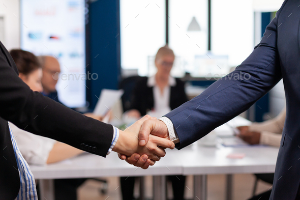 Satisfied businessman company employer wearing suit handshake new employee
