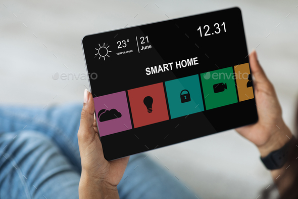 Smart home control concept. Black woman using digital tablet, cropped