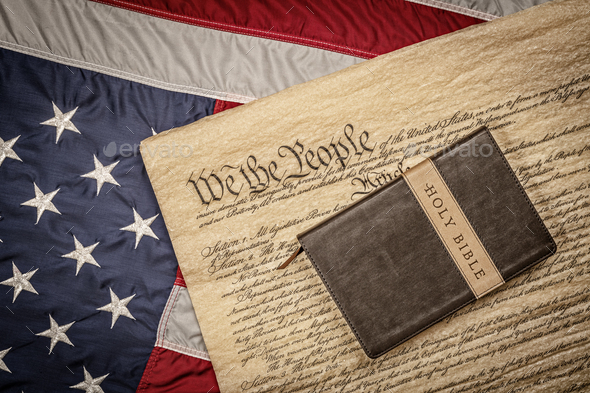 Holy bible on constitution and American Flag - Stock Photo - Images