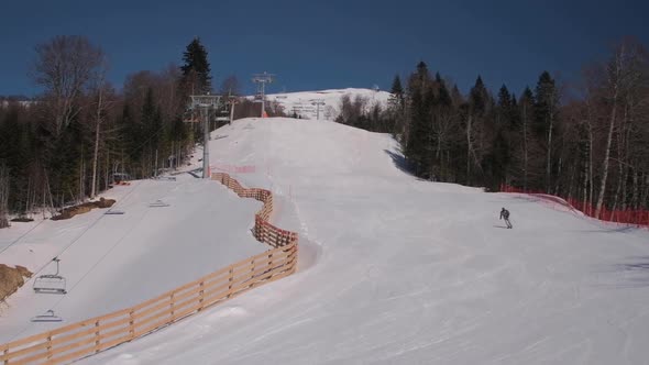 Ski resort in Kolasin, Montenegro. View of the mountain landscape with skiers and snowboarders alt