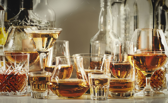Strong alcohol drinks, hard liquors, spirits and distillates iset in glasses and bottles