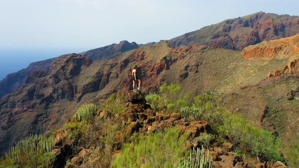 Young Woman Climbed the Peak of the Mountain alt