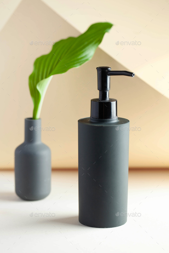 Gray cosmetic dispenser with space for your logo. Spa concept, skin care.