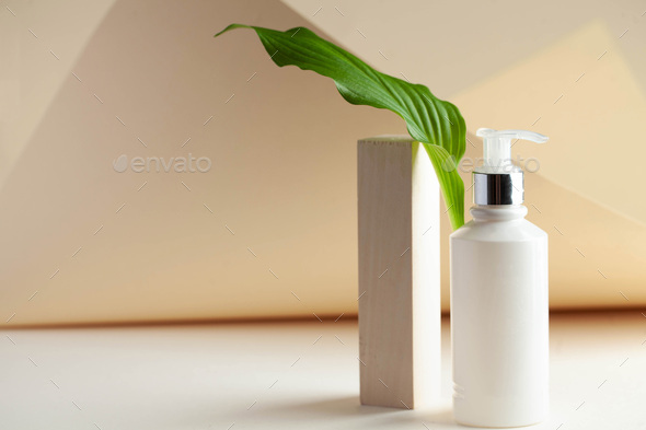 White cosmetic dispenser with space for your logo. Spa concept, skin care. Copy space.