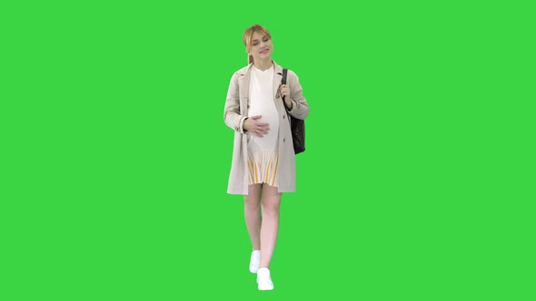 Happy Healthy Pregnancy Pregnant Young Blonde Caucasian Woman Walking on a Green Screen, Chroma Key. alt