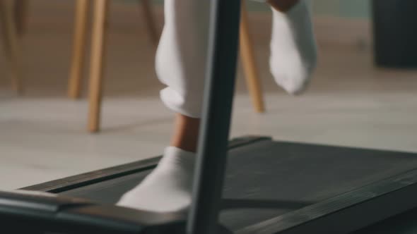 Crop Female Running on Treadmill alt
