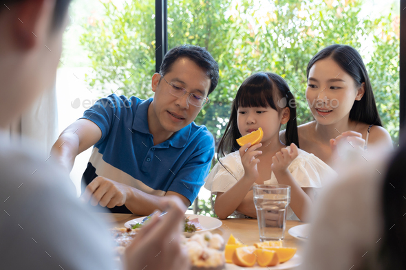 Asian Family Having A Happy Meal Stock Photo By Pondsaksit 