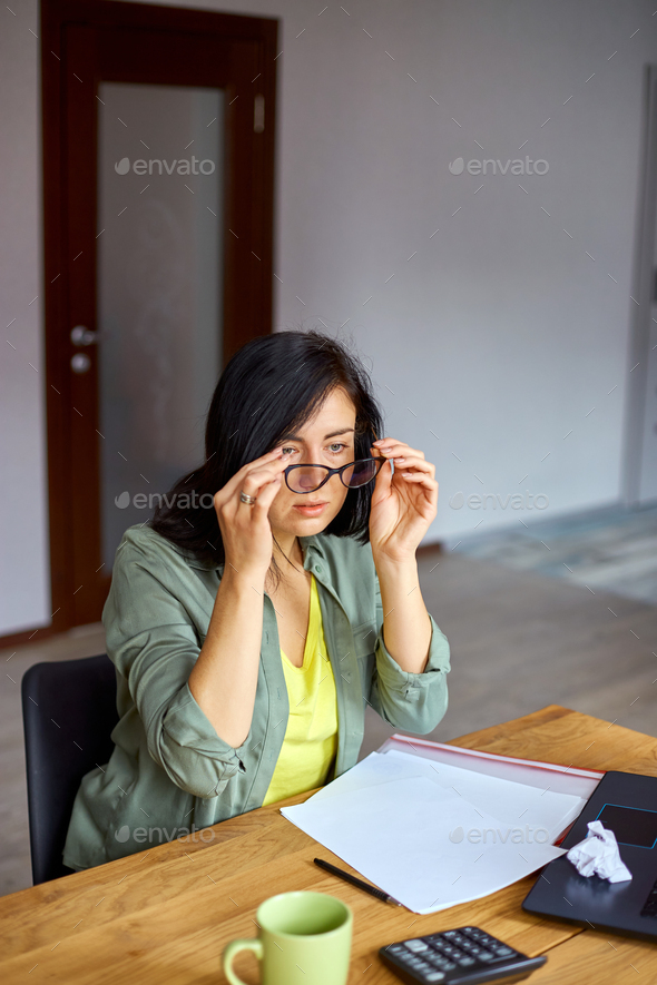 OVerworked female feeling eye strain after using computer working home