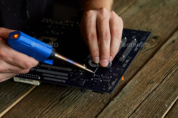 Engineer Or Technician Repair Electronic Circuit Board With Soldering Iron Stock Photo By Bondarillia