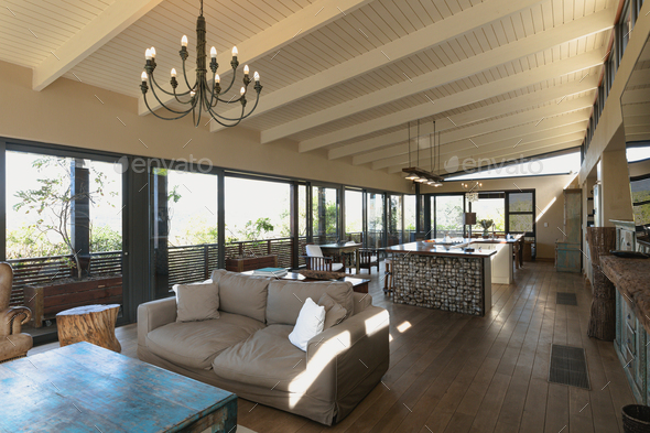 Interior of open plan kitchen diner and living room of comfortable home, with windows to terrace - Stock Photo - Images