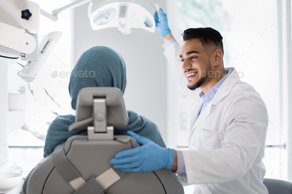 Young Arab Dentist Doctor Having Check Up With Islamic Female Patient - Stock Photo - Images