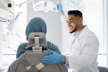 Young Arab Dentist Doctor Having Check Up With Islamic Female Patient
