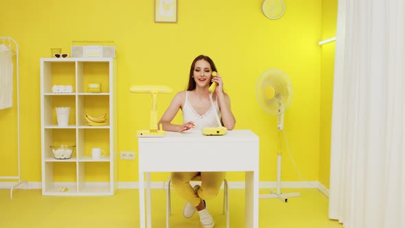 Happy Businesswoman Has Phone Conversation In Office alt