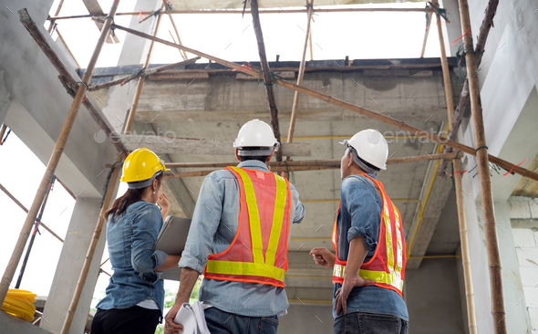 The engineering team working at building site meeting and discussing on laptop. - Stock Photo - Images