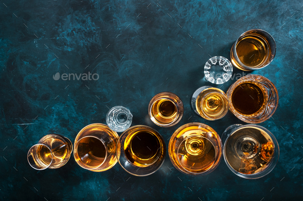 hard liquors, spirits and distillates set in glasses: cognac, scotch, whiskey and other.