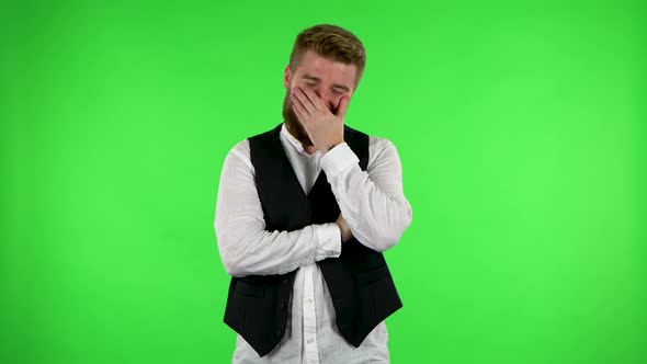 Guy Is Talking To Someone, Smiling and Shaking His Head with Assent, Showing the Like Sign. Green alt