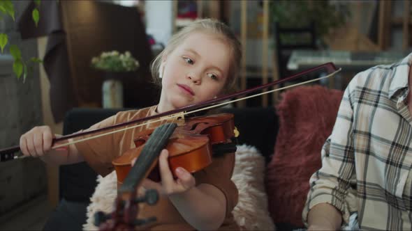 The Girl Plays the Violin with Perseverance and Patience alt