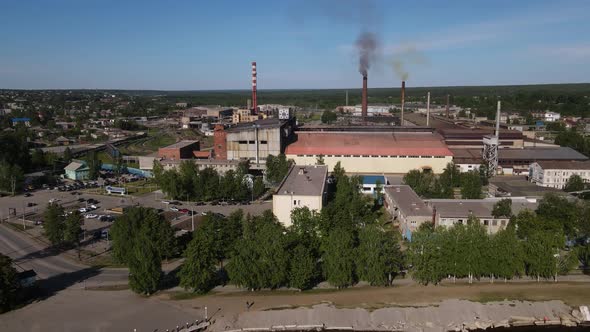 Smoking Pipes of Factory in Town in Summer
