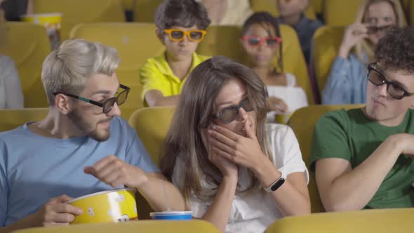 Beautiful Young Woman Picking Up Phone in Cinema Distracting People From Film, Portrait of Brunette alt