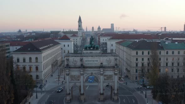 Siegestor in Munich Germany in Beautiful Sunset Dusk Scenic Cityscape with University in Background alt
