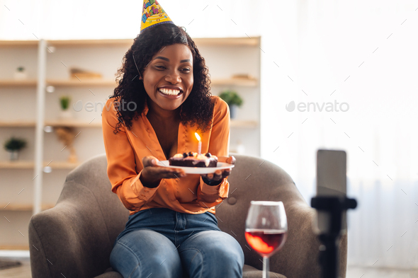 African Female Holding Birthday Cake Near Phone Celebating Online Indoor