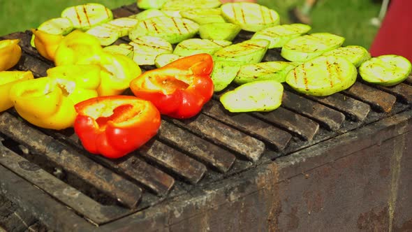 Zucchini and bell pepper fries on the grill. Vegetarian dish. Cooking vegetables without oil alt