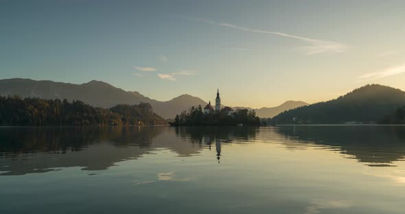 Timelapse View of the Colorful Forest and Lake Bled with a Small Island with a Church. Sunrise in