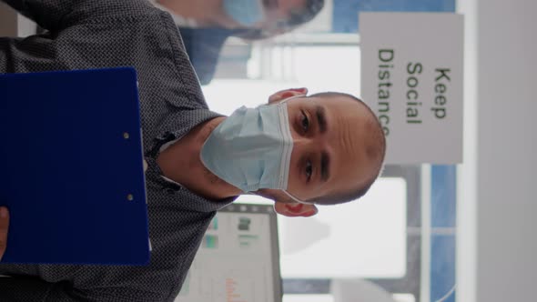 Vertical Video Pov of Businessman in Face Mask to Avoid Infection Talking on Online Video Call alt