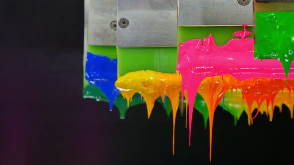 Several Ink Stuck On Green Rubber Handle Are Sliding In Black Background. alt